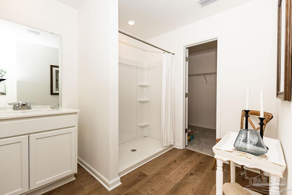 5368 Azimuth Way Milton, FL 32583 - Photo 10 of 19 a bathroom with a shower sink and mirror