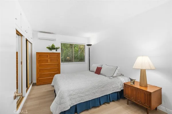 a bedroom with a bed lamp and a window