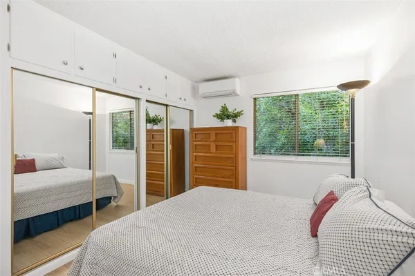 a bedroom with a large bed and a large window