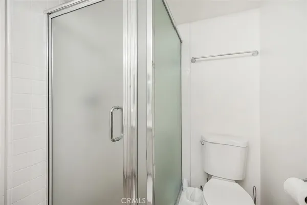 a white toilet sitting next to a bathroom sink