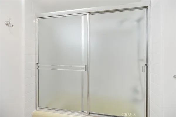 a bathroom with a glass shower door