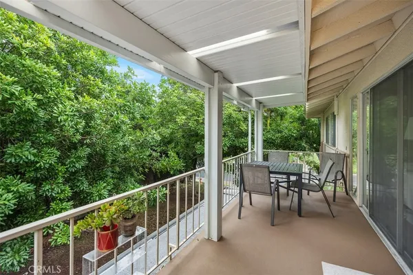 a view of a patio with a table chairs and backyard