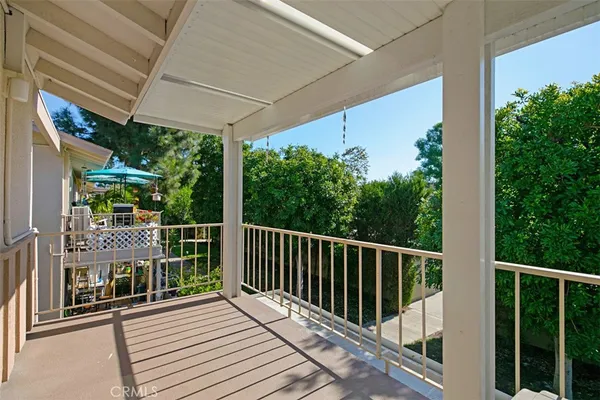a view of a balcony with wooden floor