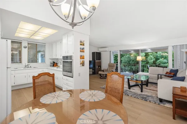 a living room with furniture a flat screen tv and a large window