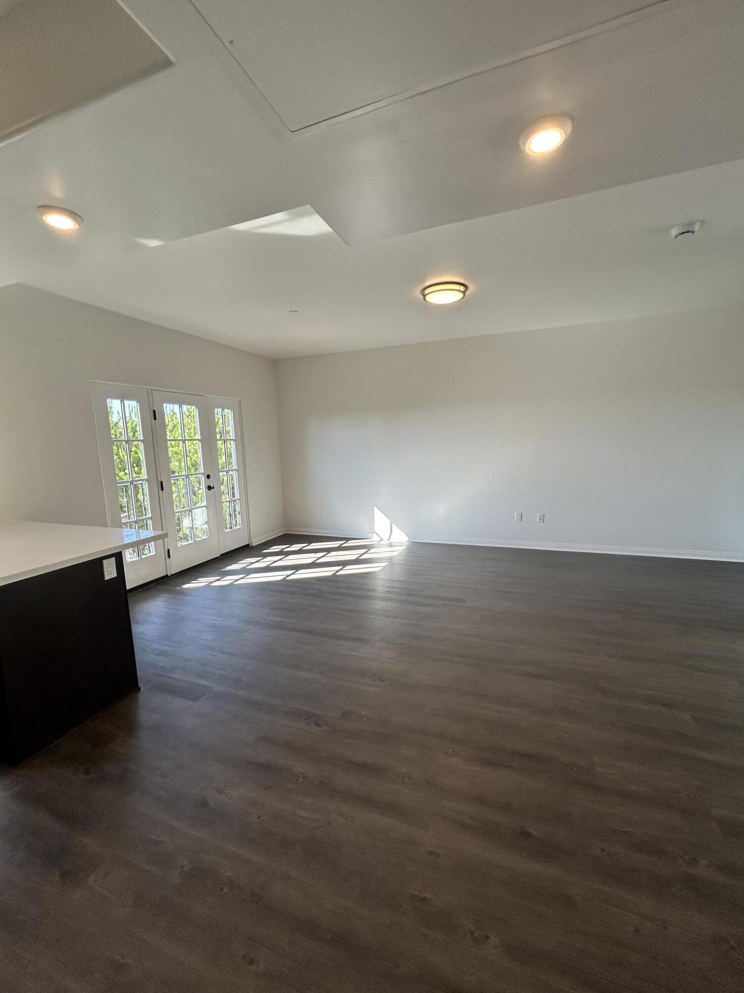 920 Lowena Drive, Unit 9 Santa Barbara, CA 93103 - Photo 1 of 10 an empty room with wooden floor and windows