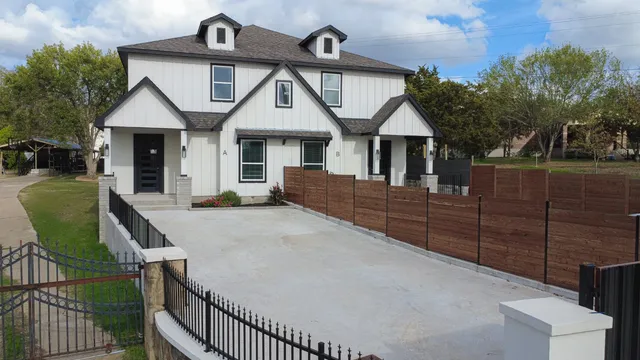 a front view of a house with wooden fence