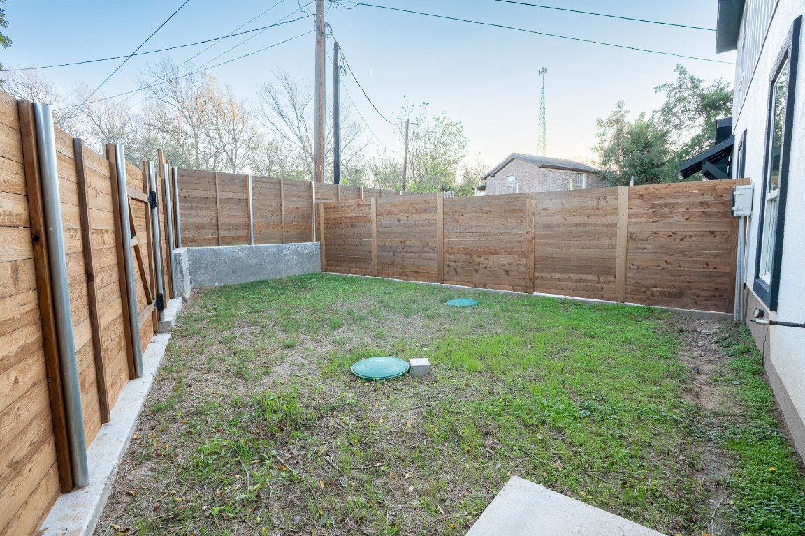 162 Meadow View Boulevard, Unit A Del Valle, TX 78617 - Photo 15 of 30 a view of a backyard with wooden fence