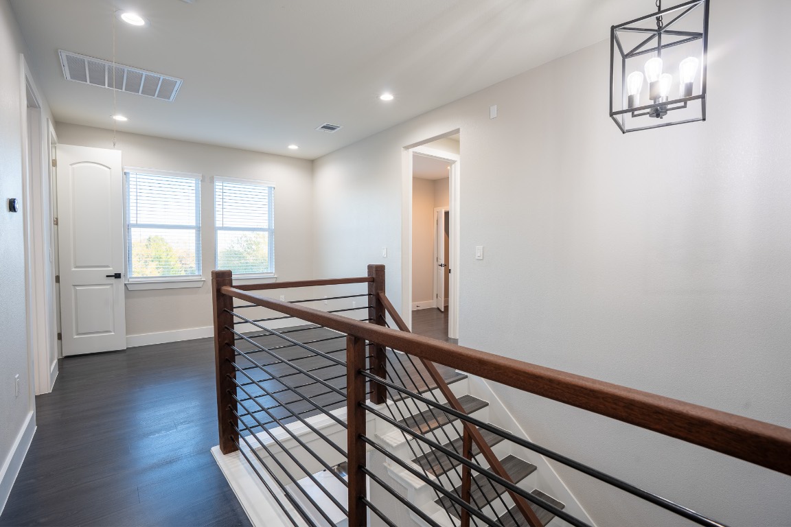 162 Meadow View Boulevard, Unit A Del Valle, TX 78617 - Photo 17 of 30 a view of a hallway with wooden floor and staircase