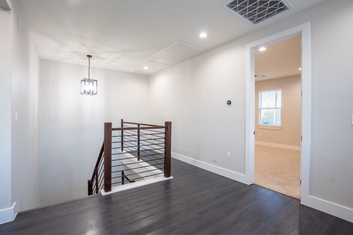 162 Meadow View Boulevard, Unit A Del Valle, TX 78617 - Photo 18 of 30 an empty room with wooden floor and windows