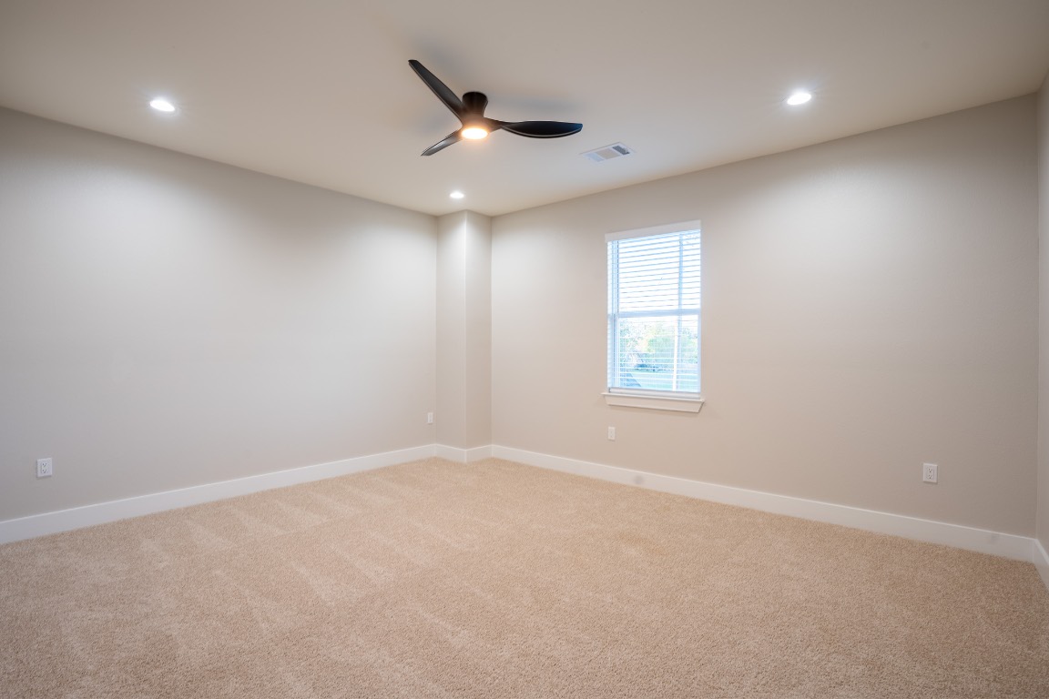 162 Meadow View Boulevard, Unit A Del Valle, TX 78617 - Photo 19 of 30 an empty room with a ceiling fan and window