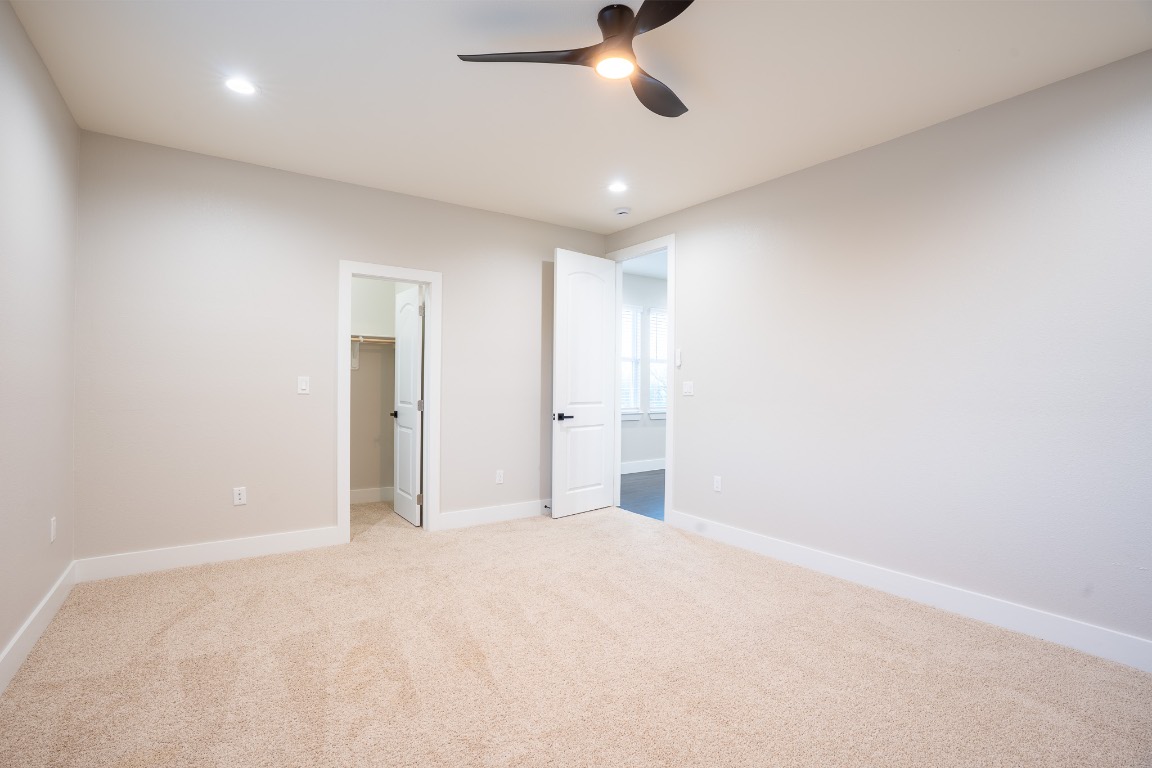 162 Meadow View Boulevard, Unit A Del Valle, TX 78617 - Photo 20 of 30 en empty room with a ceiling fan and window
