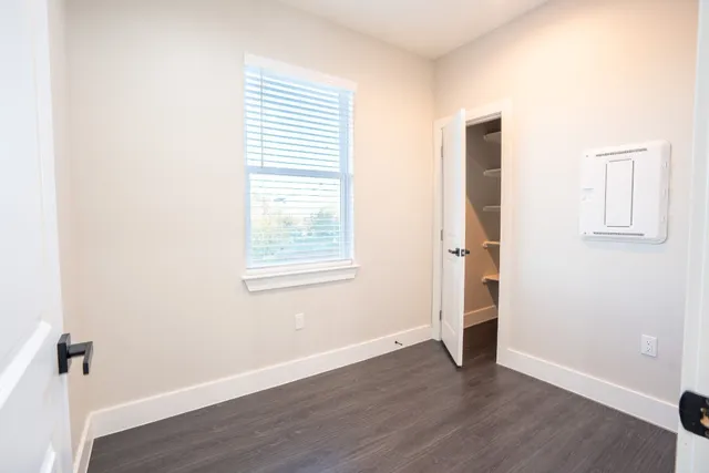 en empty room with a ceiling fan and window