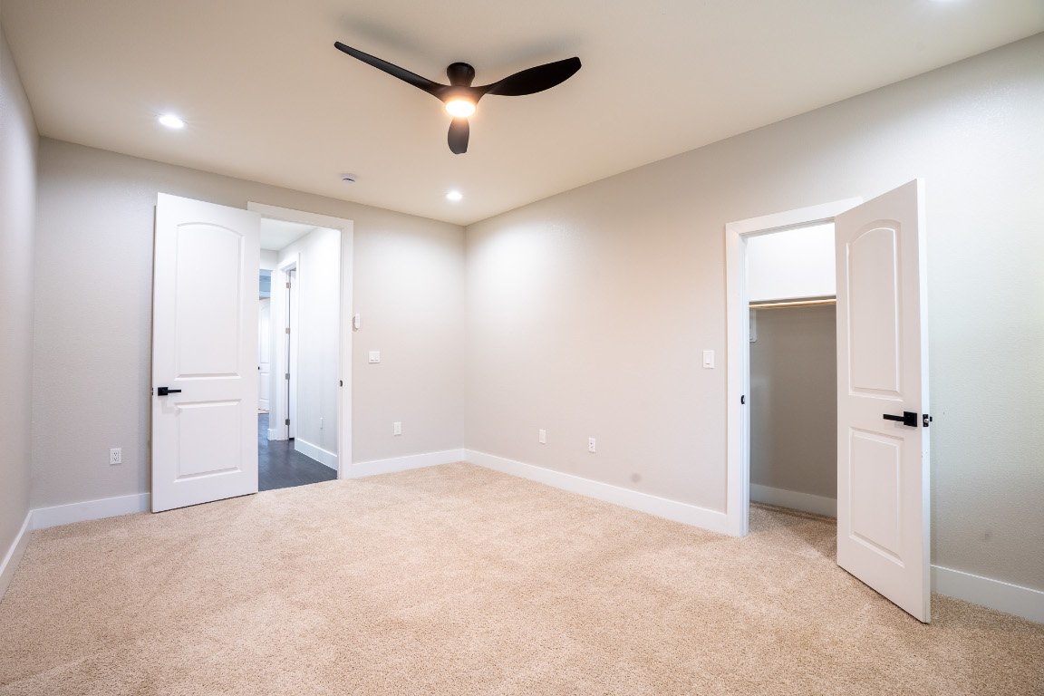 162 Meadow View Boulevard, Unit A Del Valle, TX 78617 - Photo 25 of 30 an empty room with closet and a chandelier fan