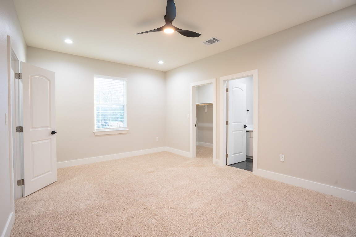 162 Meadow View Boulevard, Unit A Del Valle, TX 78617 - Photo 26 of 30 an empty room with windows and closet
