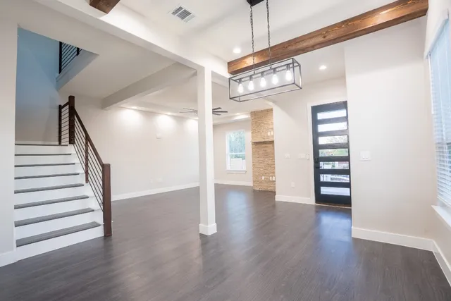 a view of a hallway with wooden floor and entryway