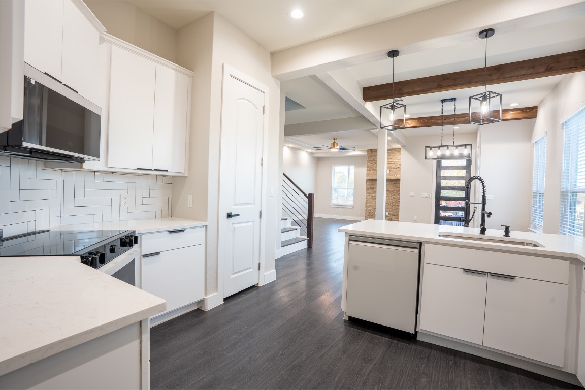 162 Meadow View Boulevard, Unit A Del Valle, TX 78617 - Photo 7 of 30 a kitchen with a sink stainless steel appliances a counter top space and cabinets