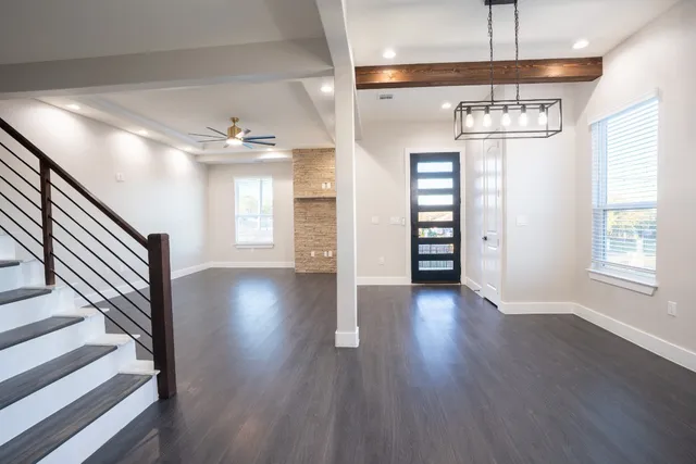 a kitchen with a sink stainless steel appliances a counter top space and cabinets