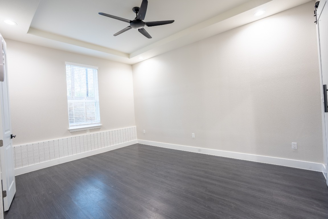 162 Meadow View Boulevard, Unit A Del Valle, TX 78617 - Photo 9 of 30 wooden floor in an empty room with a window