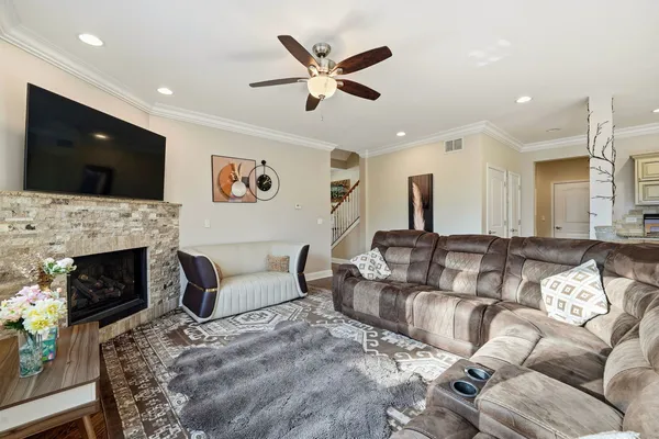 a living room with furniture a fireplace and a flat screen tv