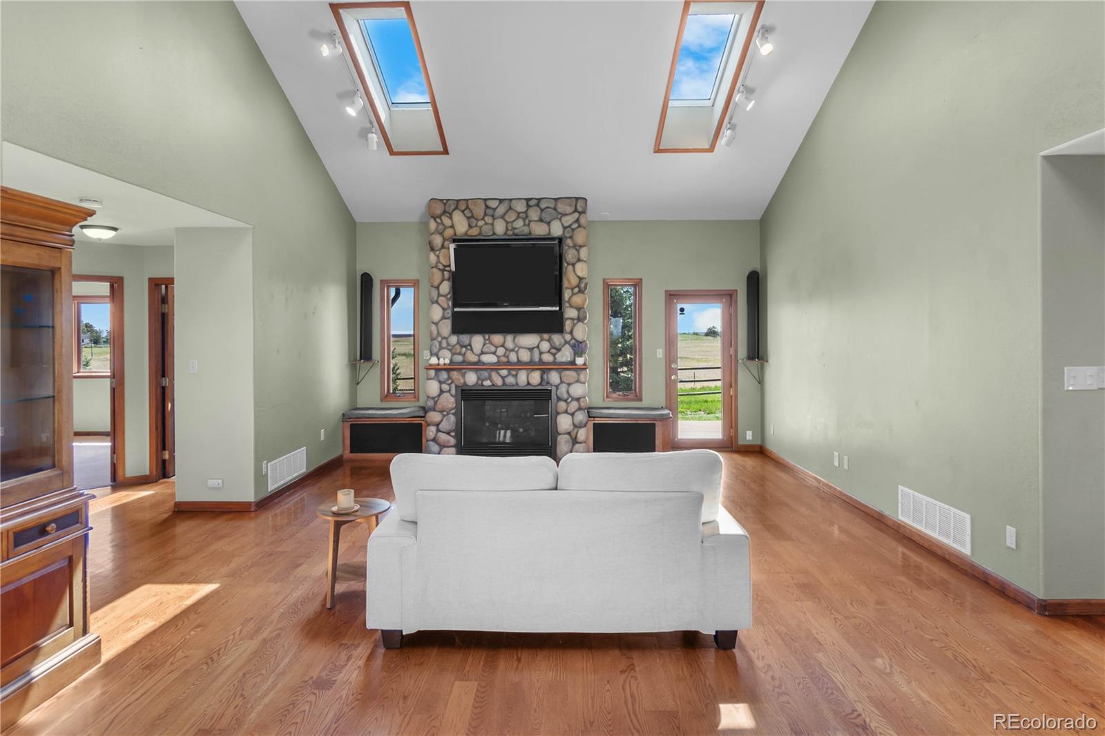 74 Rocky Cliff Road Elizabeth, CO 80107 - Photo 7 of 50 a living room with furniture a fireplace and a flat screen tv