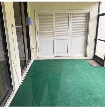 a view of front door with a yard