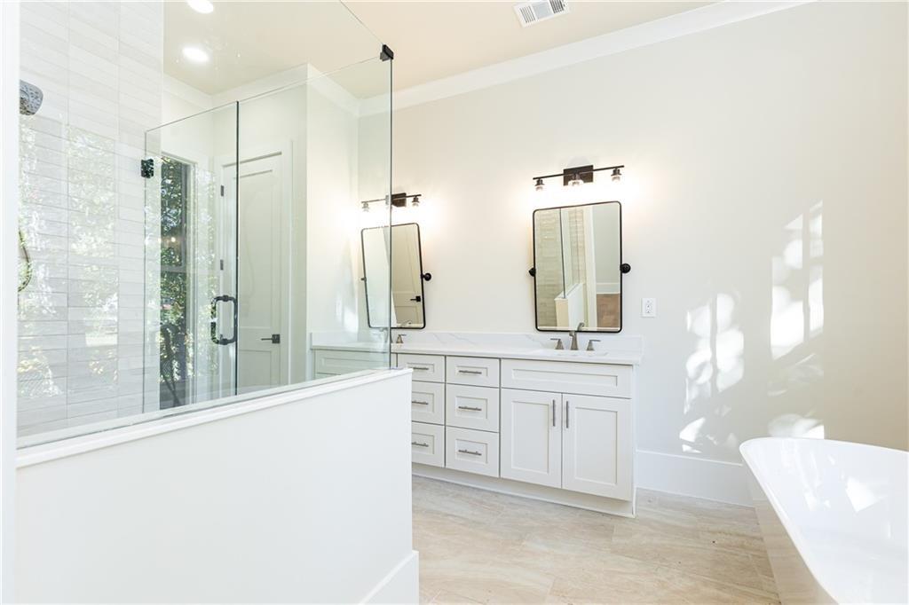 1967 Highgrove Court Decatur, GA 30033 - Photo 22 of 60 a spacious bathroom with a double vanity sink a mirror and a shower