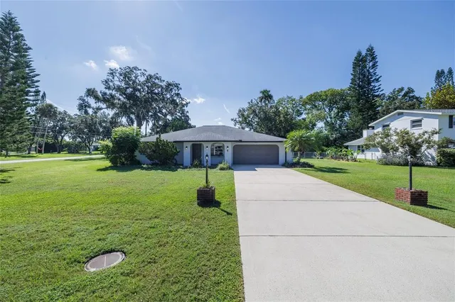 a view of a house with garden and trees