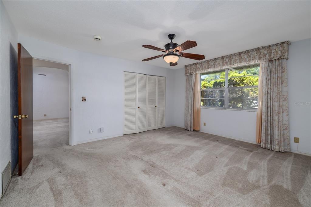 901 Duncan Road South Daytona, FL 32119 - Photo 11 of 22 an empty room with windows and a ceiling fan