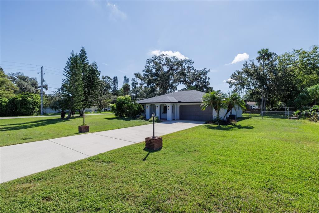 901 Duncan Road South Daytona, FL 32119 - Photo 2 of 22 a view of a house with garden and trees