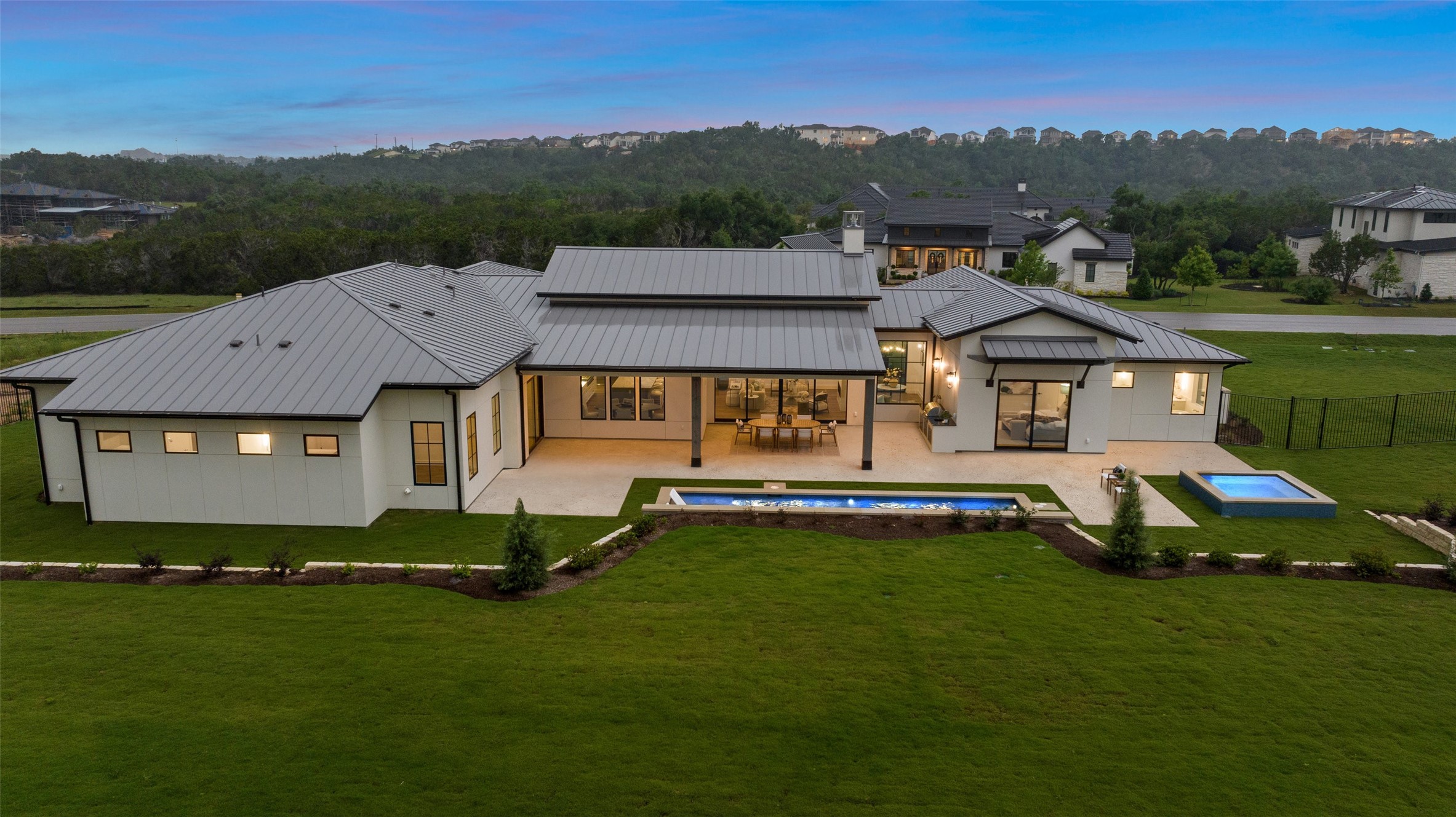 17212 Morning Grove Lane Austin, TX 78738 - Photo 35 of 38 a front view of a house with a garden and swimming pool