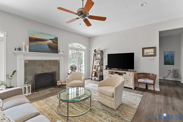 a living room with furniture a fireplace and a flat screen tv