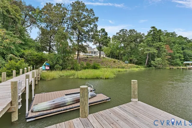 a view of a deck with lake and wooden floor