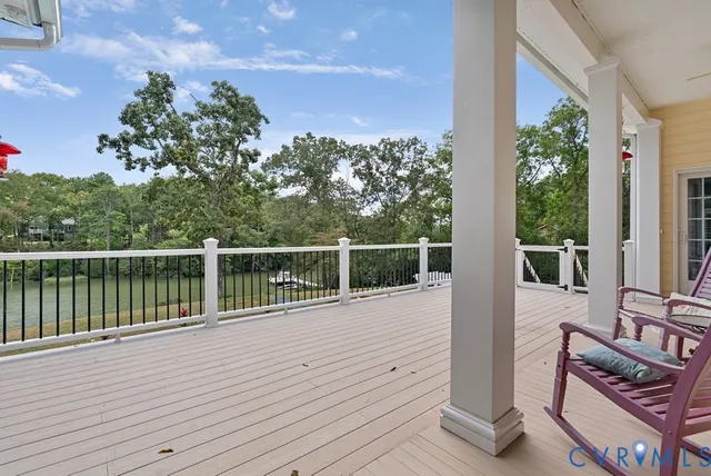 a balcony with wooden floor and lake view