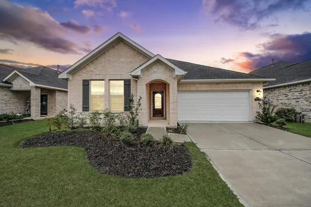an empty room with ceiling fan and window