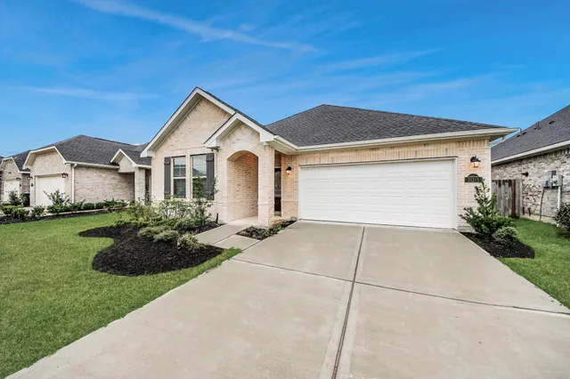 a bathroom with a granite countertop tub sink and mirror