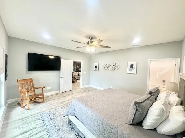 a bedroom with a bed tv and couch