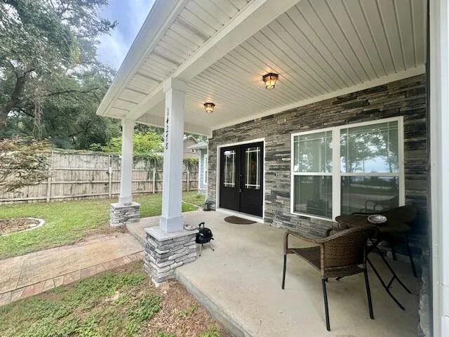 a patio with yard glass top table and chairs