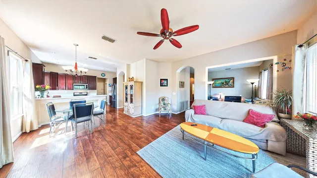 a living room with furniture and kitchen view