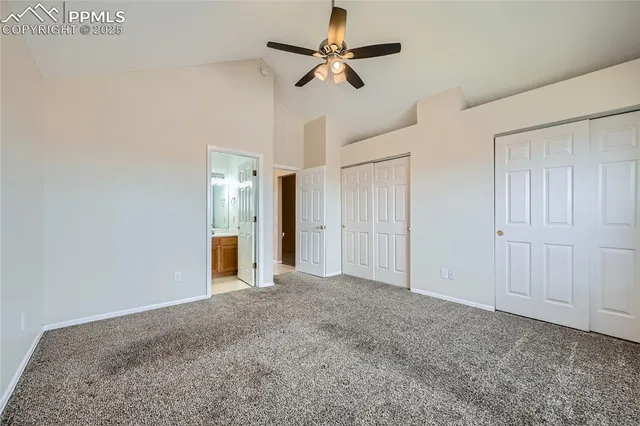 a view of an empty room and a ceiling fan