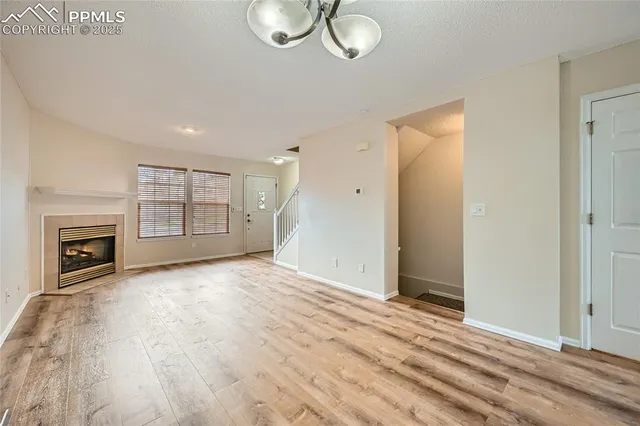 wooden floor fireplace and natural light in room