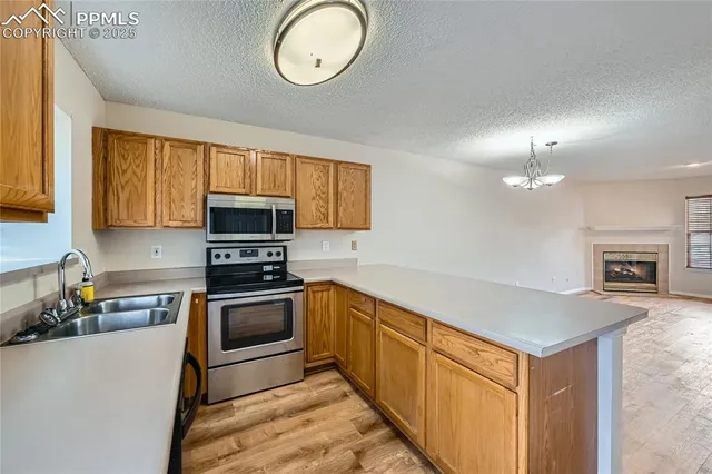 a kitchen with granite countertop a stove top oven sink and cabinets
