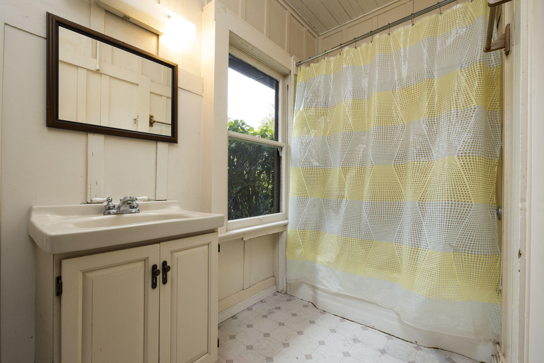 4822 9th Street Carpinteria, CA 93013 - Photo 13 of 22 a bathroom with a sink a mirror and a shower
