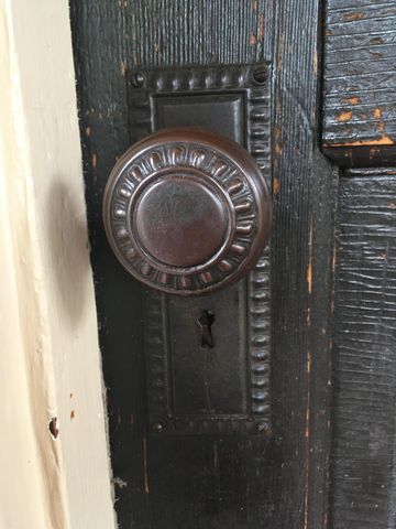 an empty room with windows and entrance