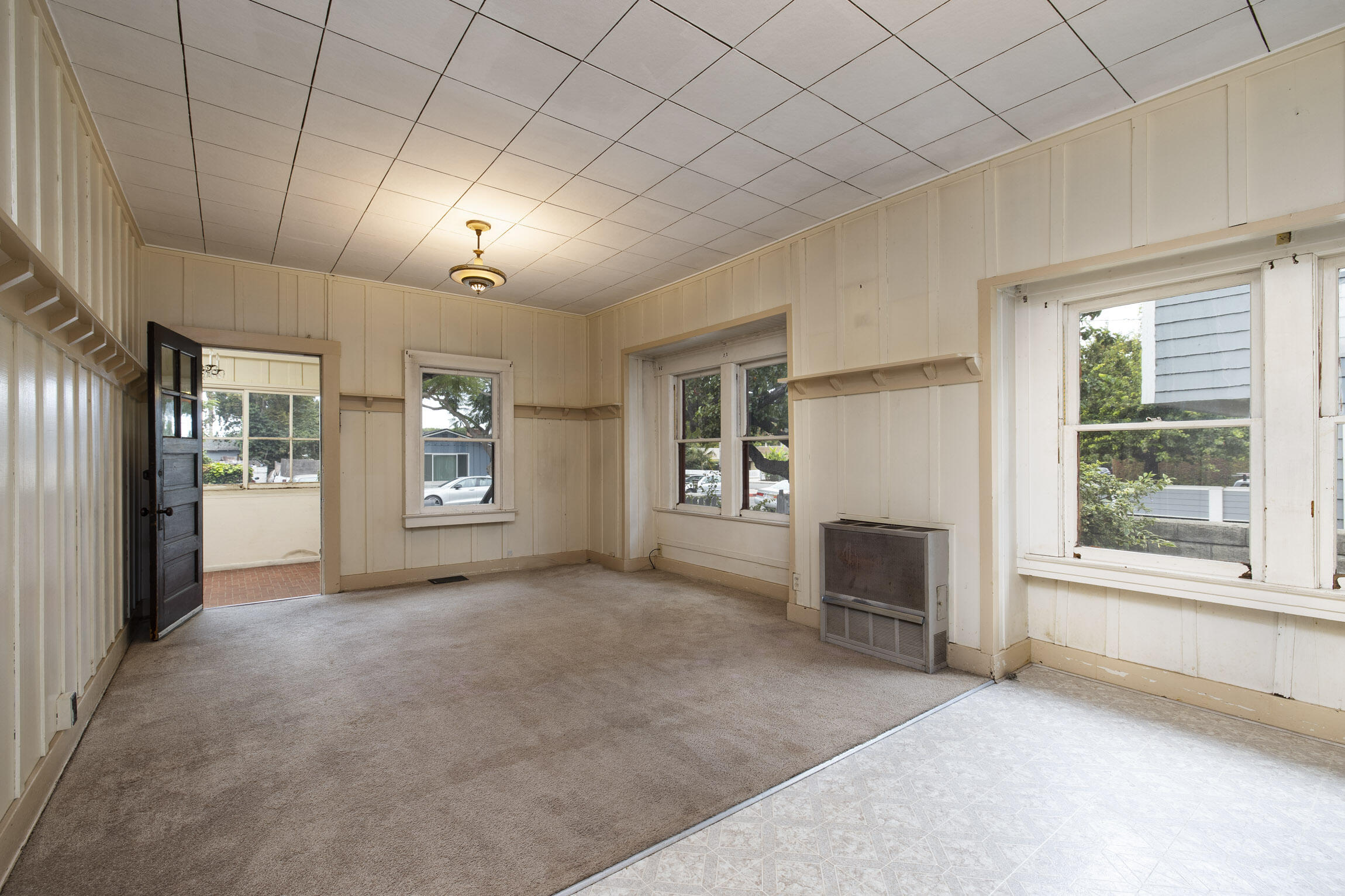 4822 9th Street Carpinteria, CA 93013 - Photo 10 of 22 an empty room with fireplace and windows