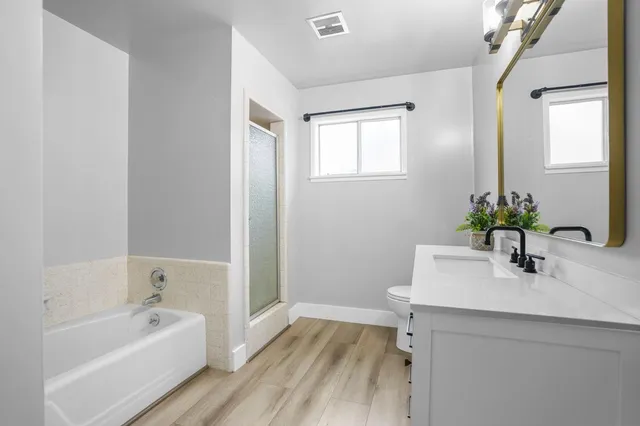 a bathroom with a sink a bathtub and a mirror