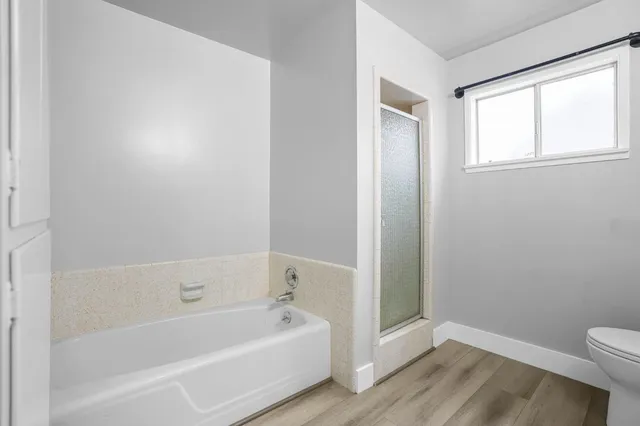 a white bath tub sitting next to a white toilet