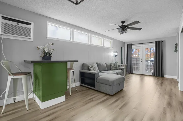 a living room with furniture and a wooden floor