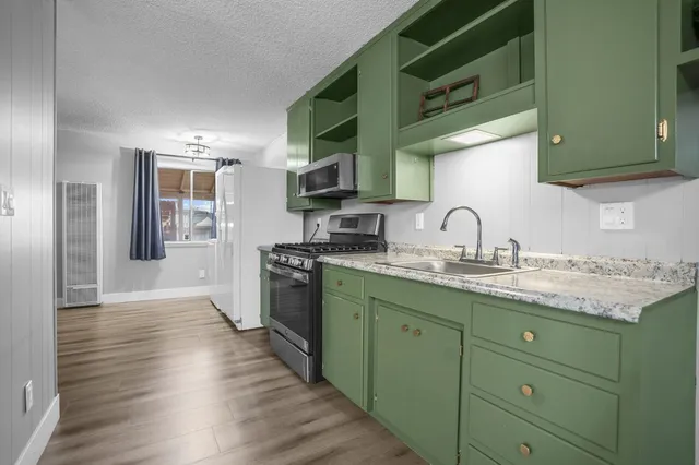 a kitchen with a sink cabinets and stainless steel appliances