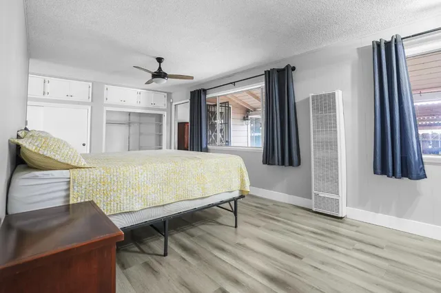 a living room with a balcony furniture and a flat screen tv