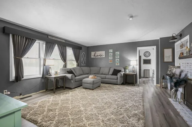 a living room with furniture and large windows